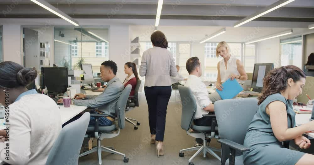 Busy activity in diverse business office with business people working multi tasking in workplace discussing growth ideas and networking
