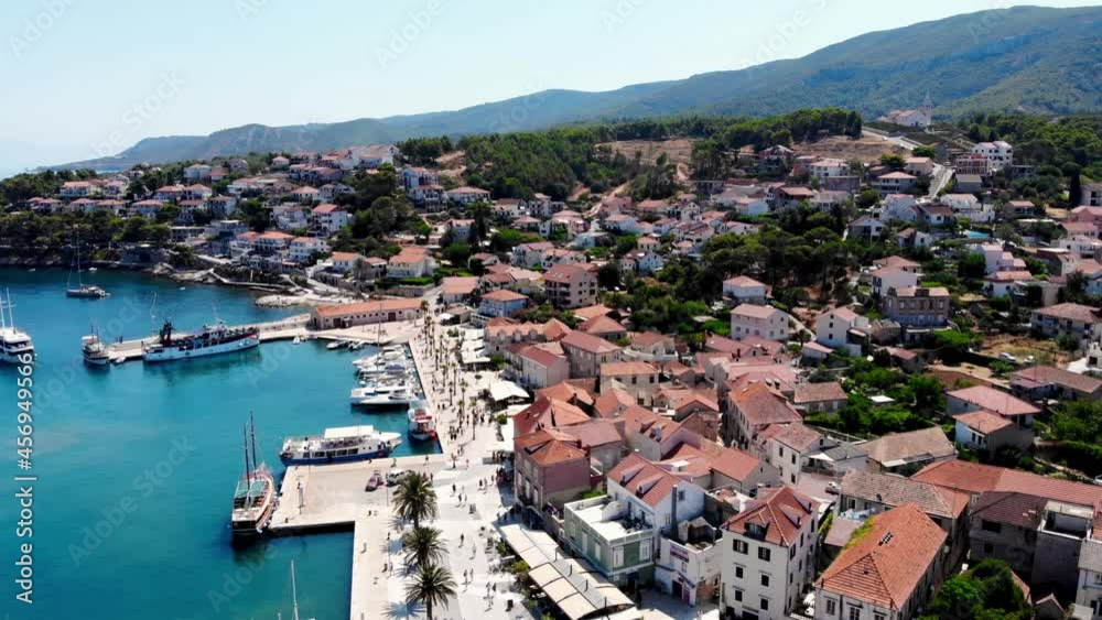 Drone shot on the Croatian resort island of Hvar in the Adriatic Sea. View from the drone to the port. Boats and ships on the shores of the Adriatic Sea in Croatia. Mountains on the island of Hvar. Drone shot on the Croatian resort island of Hvar in the Adriatic Sea. View from the drone to the port. Boats and ships on the shores of the Adriatic Sea in Croatia. Mountains on the island of Hvar.