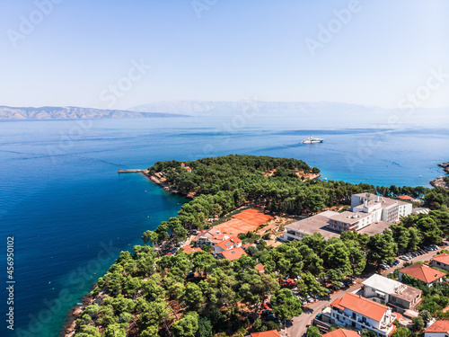Drone shot on the Croatian resort island of Hvar in the Adriatic Sea. View from the drone to the port. Boats and ships on the shores of the Adriatic Sea in Croatia. Mountains on the island of Hvar. 