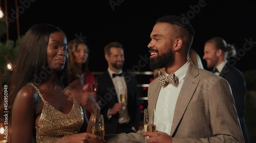 Beautiful young African couple smiling while spending time on night party 
