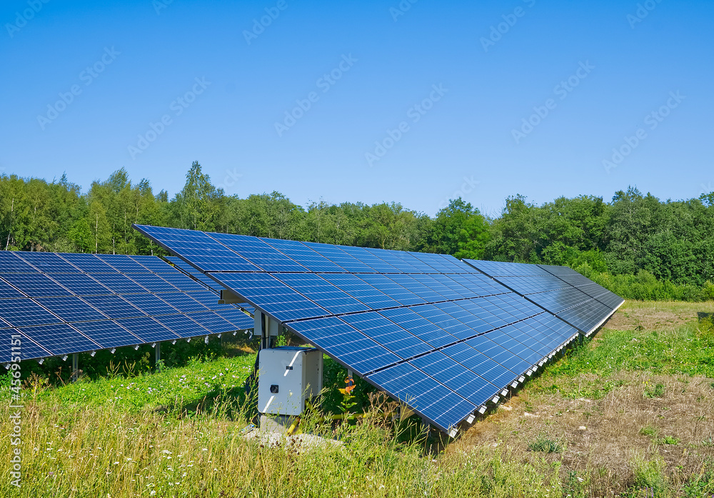Solar power plant in summer day. Photovoltaic panels for renewable electric production. Solar panel power station landscape photography Solar power plant in summer day. Photovoltaic panels for renewable electric production. Solar panel power station landscape photography