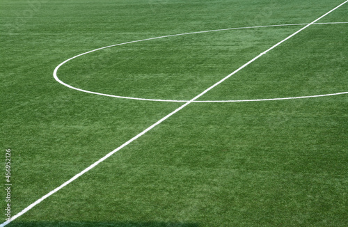 The geometric shapes drawn by the white lines of a football field.
