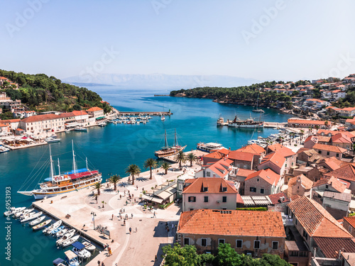 Drone shot on the Croatian resort island of Hvar in the Adriatic Sea. View from the drone to the port. Boats and ships on the shores of the Adriatic Sea in Croatia. Mountains on the island of Hvar. 