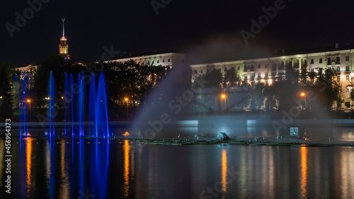 Multicolored musical fountain on a river at night. The fountain in the night from illumination. Long exposure.