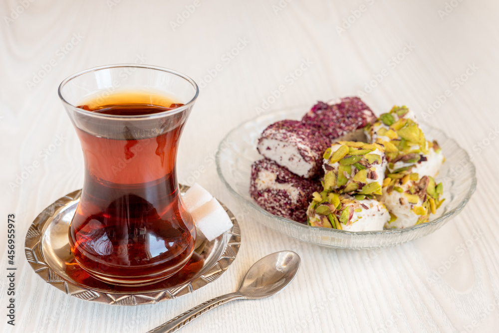 Traditional Turkish tea in a glass with sweets Traditional Turkish tea in a glass with sweets