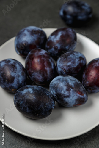 Fresh plums. Fruits. On a dark background. Copy space.