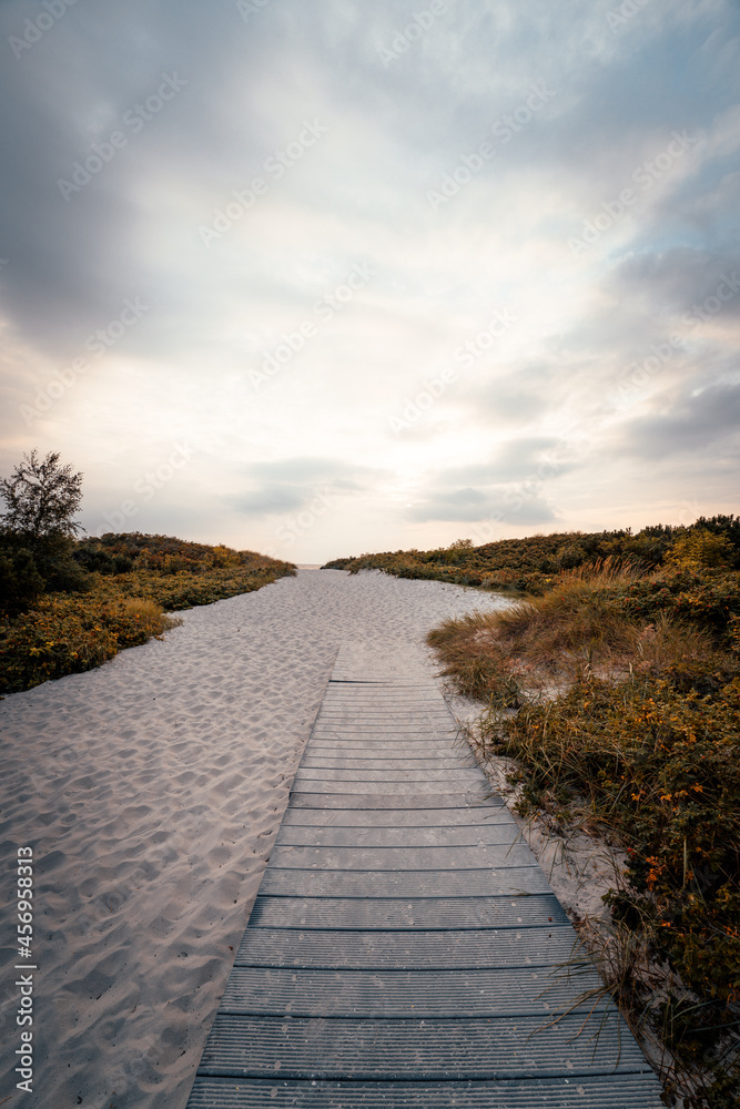 Wooden pathway on the popular white sand beach in Lomma, Sweden.