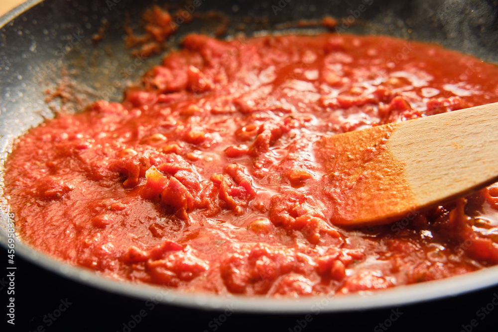 Cooking tomato sauce on frying pan Cooking tomato sauce on frying pan