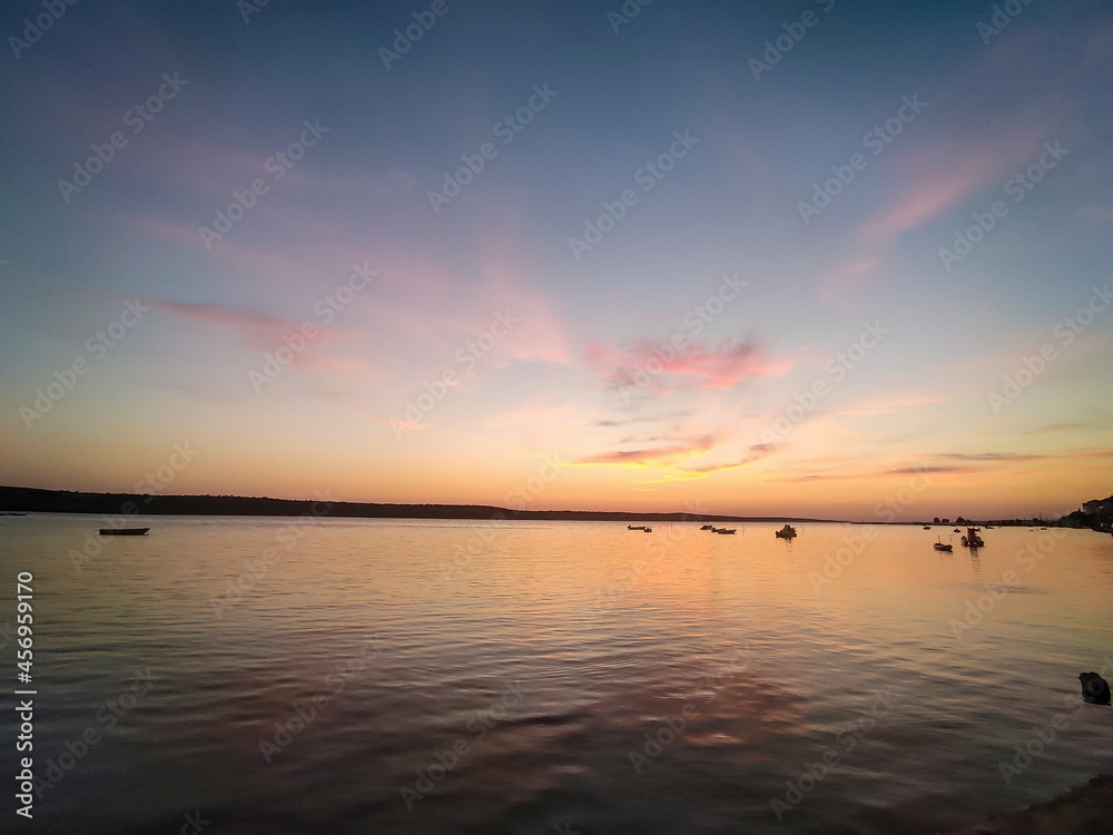 wonderful sunset in croatia with boats in the middle at sunset