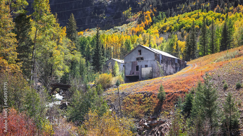 Old mine in San Juan mountains surrounded with fall foliage