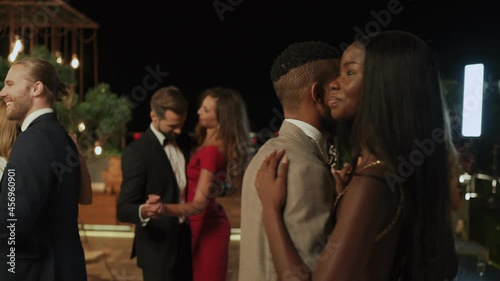 Beautiful young people dancing and smiling while spending time on luxury party 