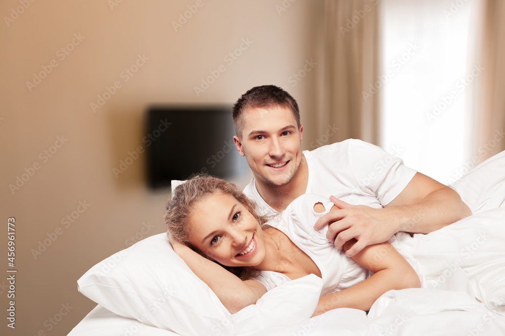 Calm young fun satisfied positive woman wearing pajamas lying on bed Calm young fun satisfied positive woman wearing pajamas lying on bed