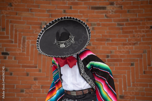 Mexican charro dancer with sombrero and multicolored serape from jalisco mexico with mariachi music photo