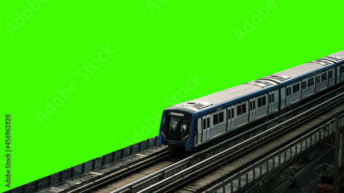Fotografía The Sky train green background, BTS Sky Train on rail tracks with traffic underneath, Aerial view of Bangkok modern office buildings and condominium