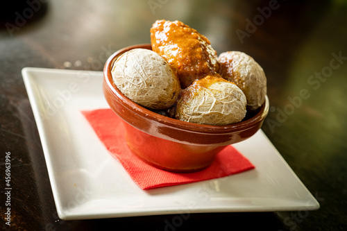 Typical wrinkled potatoes with spicy sauce in a bowl (Papas Arrugadas con Mojo Picon), Fuerteventura, Canary Islands photo