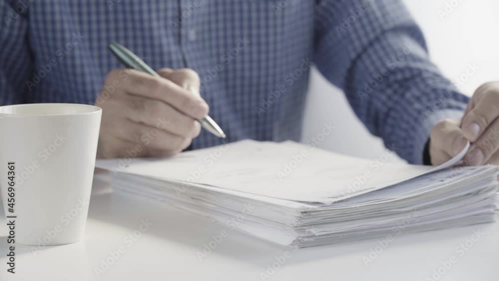 The Clerk's Hands are Working with Paper Files. Checking Business Records, Stacks of Unfinished Documents. Business Concept