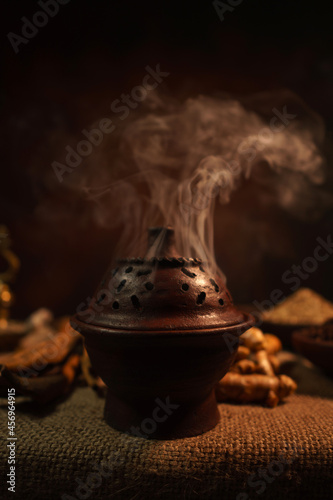 Burning incense in a traditional pottery pot