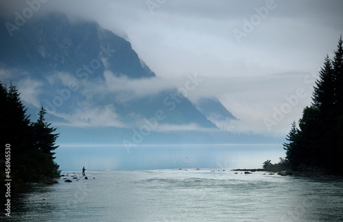 A fisherman on the misty banks of Chilkoot Lake at sunset, in Haines, Alaska photo