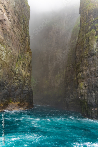 Stunning boat ride among the  steep bird cliffs  caves  narrow straits and grottoes of Vestmanna  Streymoy island  Faroe Islands