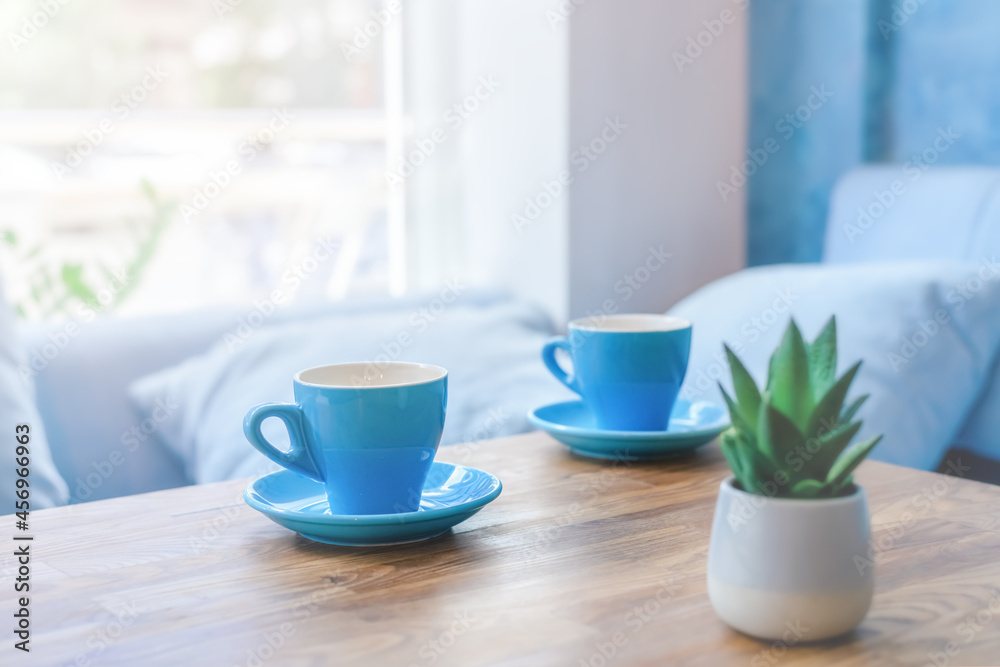 two blue cups on the table in the cafe. two blue cups on the table in the cafe.