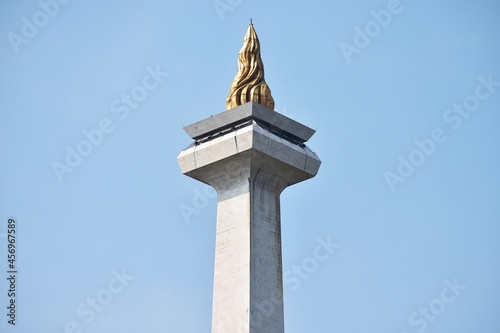 Obraz na płótnie The National Monument (Monumen Nasional) in Jakarta, Indonesia, taken in the afternoon, closeup to the crown of the monument
