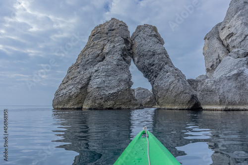 View from the nose of a green sea kayak on stones of the mount Karaul-Oba. Crimea. Novy Svet