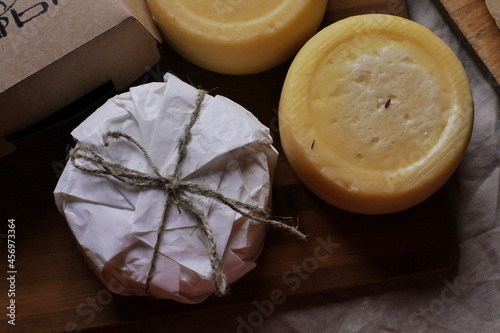 Homemade farm cheese heads on the table top view