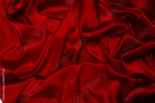 Rich and luxury red silk fabric texture background.