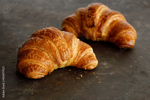 Croissant with butter two pieces on a black board. High quality photo