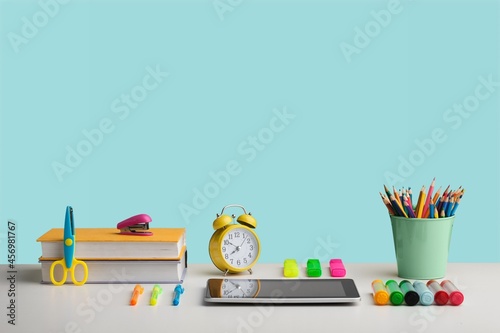 Organized office and school, stationery, notebooks pencils scissors and alarm clock