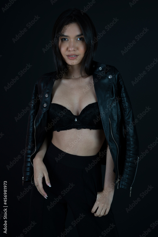 woman wearing black bra and leather jacket