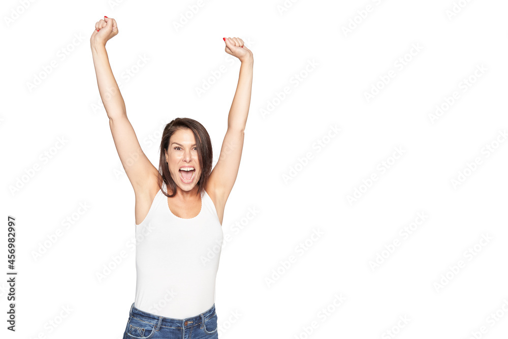 Winning girl celebrating success isolated on white background. Dressed in white tank top and denim pants. Concept of joy Winning girl celebrating success isolated on white background. Dressed in white tank top and denim pants. Concept of joy