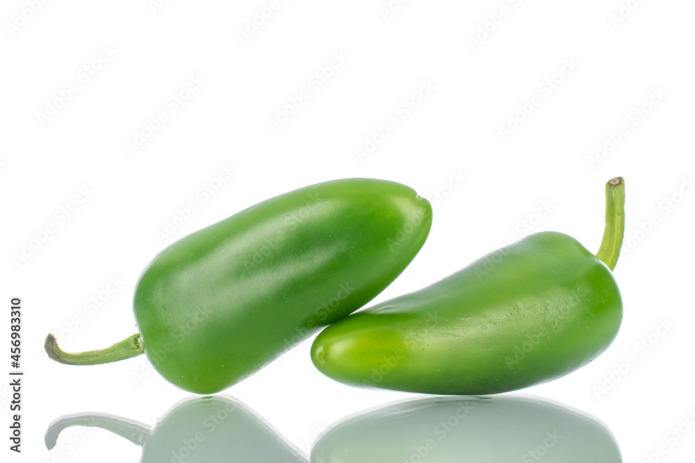 Two green spicy pepper pods, close-up, isolated on white. Two green spicy pepper pods, close-up, isolated on white.