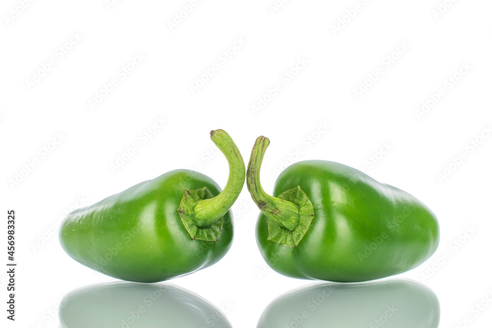 Two green spicy pepper pods, close-up, isolated on white. Two green spicy pepper pods, close-up, isolated on white.