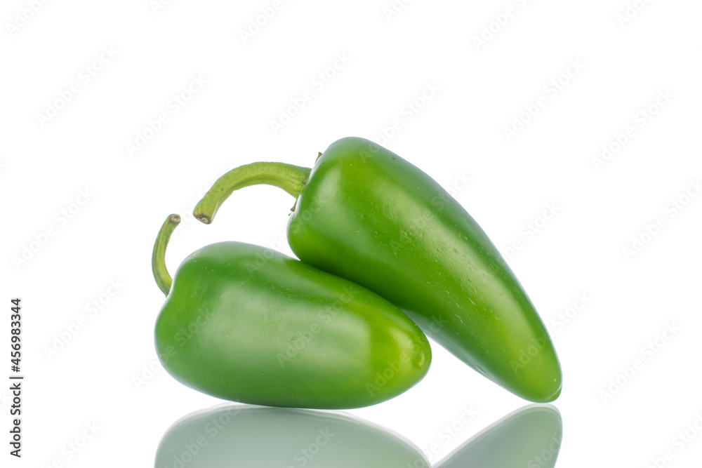 Two green spicy pepper pods, close-up, isolated on white. Two green spicy pepper pods, close-up, isolated on white.