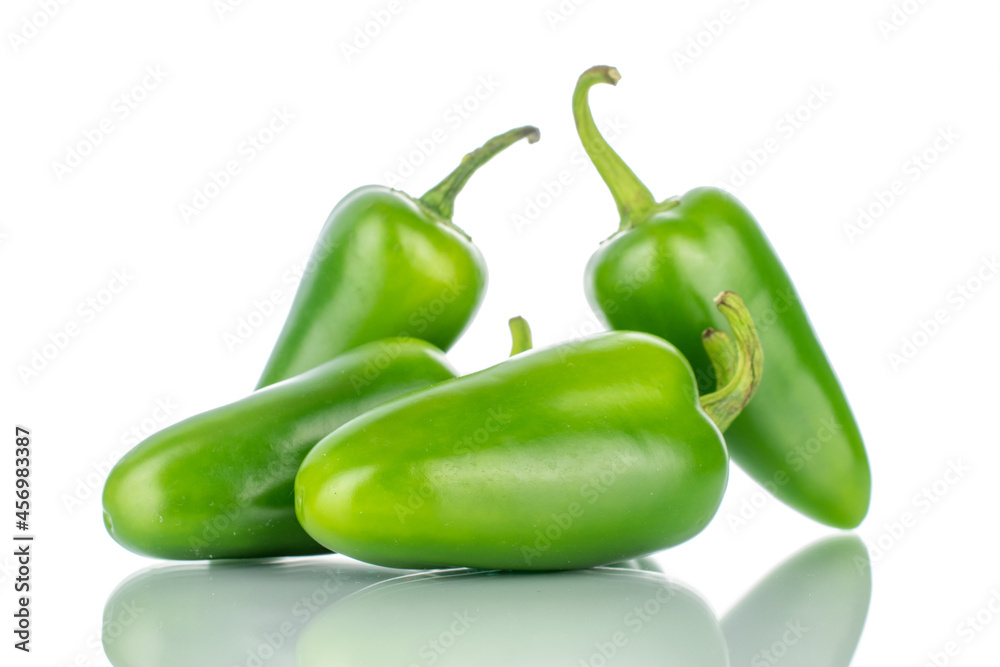 Several green spicy pepper pods, close-up, isolated on white. Several green spicy pepper pods, close-up, isolated on white.