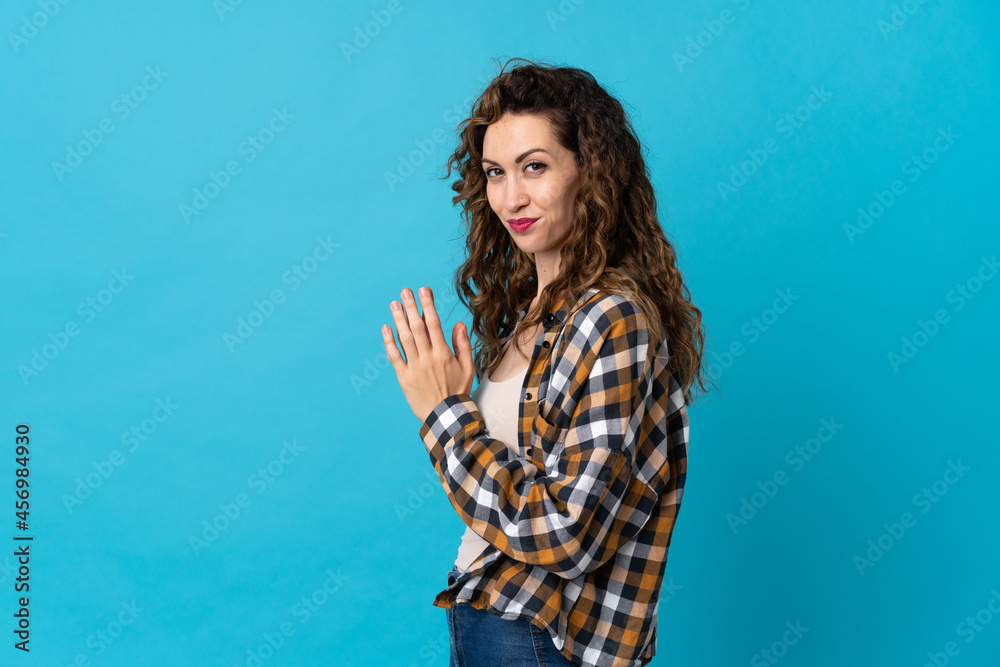 Young caucasian woman isolated on blue background scheming something Young caucasian woman isolated on blue background scheming something