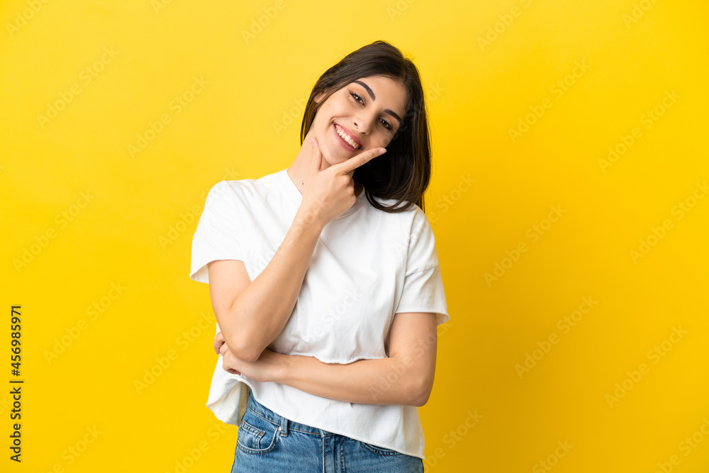 Young caucasian woman isolated on yellow background happy and smiling Young caucasian woman isolated on yellow background happy and smiling