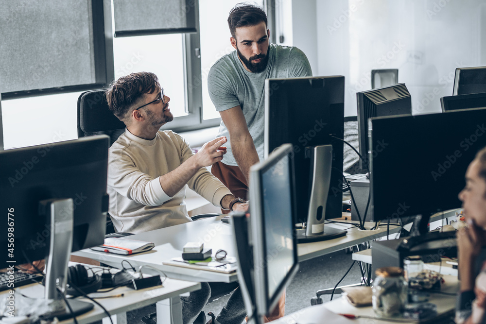 Two programmers at the office.They discuss and working on new project ...