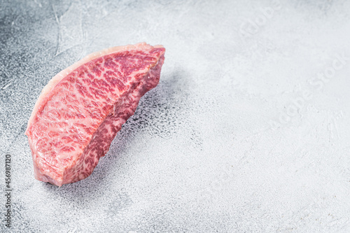 Raw wagyu rump sirloin steak, kobe beef meat. White background. Top view. Copy space photo