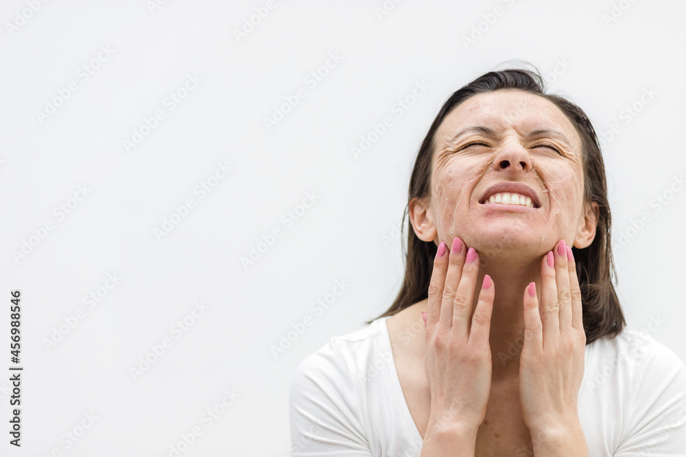 Photo of woman with dry skin touching her face on white background. Photo of woman with dry skin touching her face on white background.