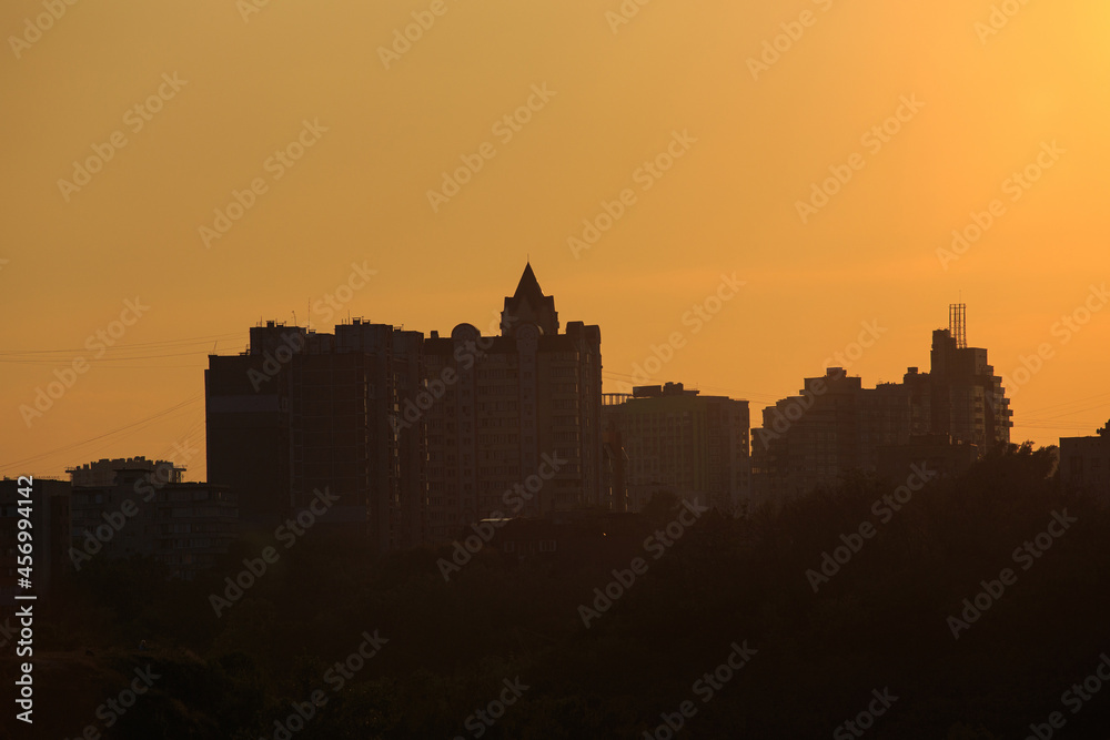 Panorama of city buildings at sunrise or sunset, the landscape of the big city with buildings of different heights