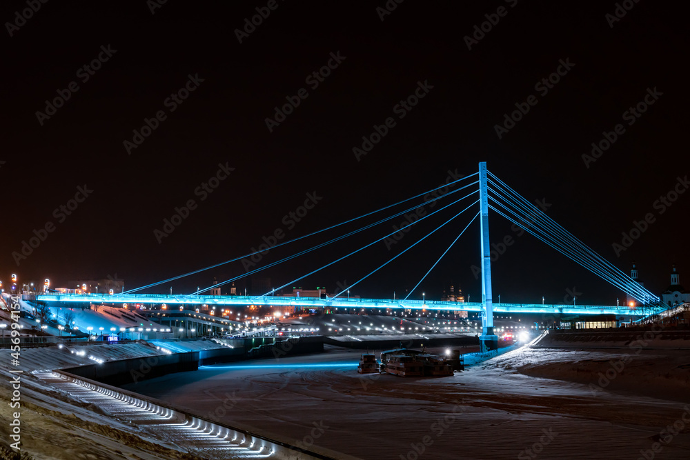 Bridge of lovers with blue illumination in Tyumen Bridge of lovers with blue illumination in Tyumen