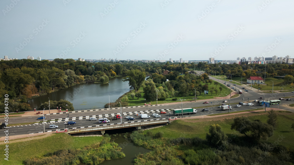 Naklejka premium An overpass across the city river. Busy freeway. Aerial photography.