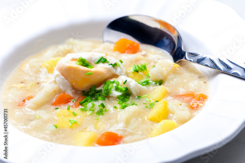 cauliflower soup with carrot, potatoes and poache egg