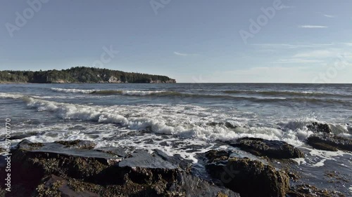 Tidal Surge Crashing into Beach Rocks