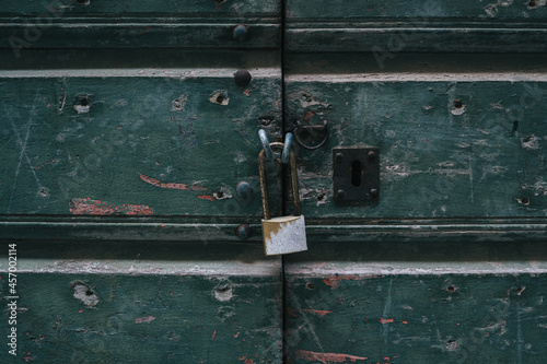 old rusty padlock on wooden door