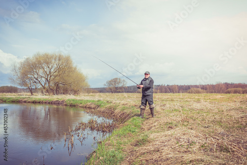 Fisherman throws a spinning rod.
