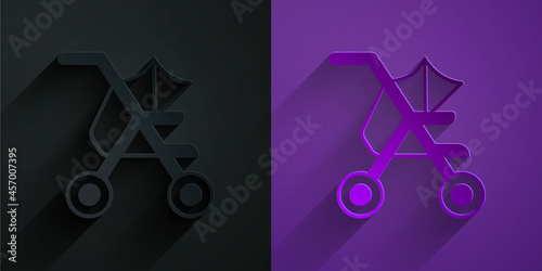 Paper cut Baby stroller icon isolated on black on purple background. Baby carriage, buggy, pram, stroller, wheel. Paper art style. Vector