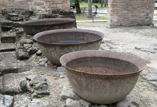 metal urns in abandoned sugar mill